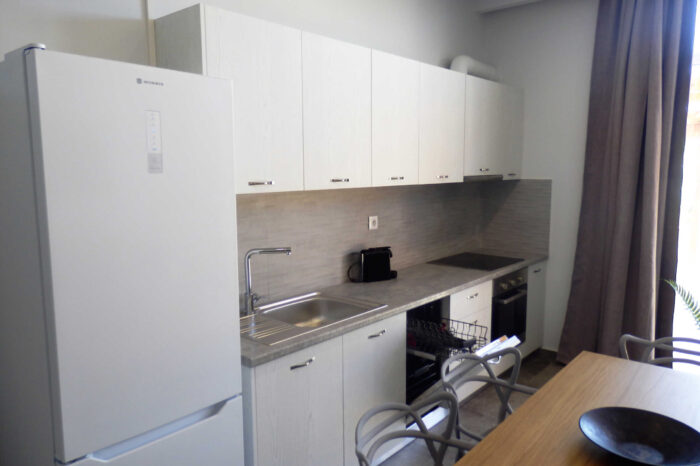 Open-plan living room and kitchen in family apartment in Ierapetra